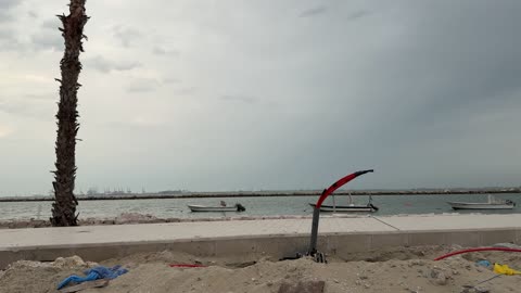 Waterfront Construction Site and Boats Under Cloudy Sky