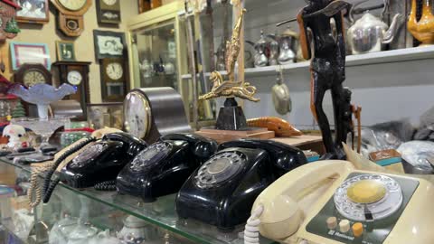 Vintage Rotary Phones and Antique Clocks Display