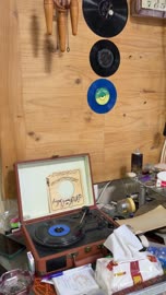 Vintage Suitcase Record Player Spinning Vinyl Indoors