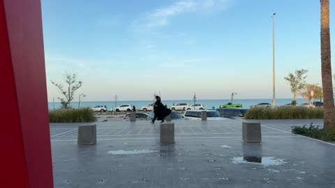Woman in Abaya Walking Along Coastal Plaza Waterfront Clip