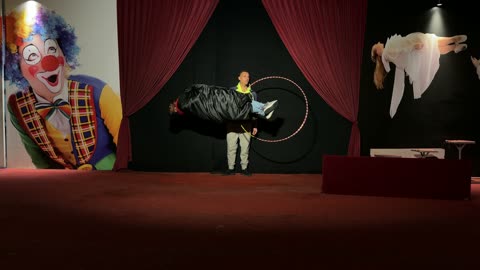 Magician Performing Levitation Illusion on Theater Stage