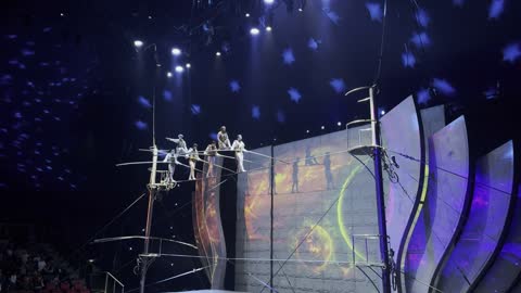 A circus performance on a tightrope in a live theater.