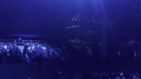 Illuminated Globe Stage Performance in Blue Theater