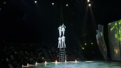 Circus Acrobats Balance Act on Ladder in Theater Show