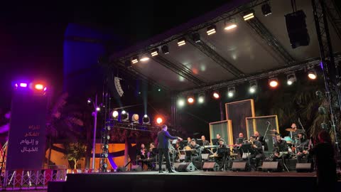 Musical Orchestra Performance on Outdoor Night Stage
