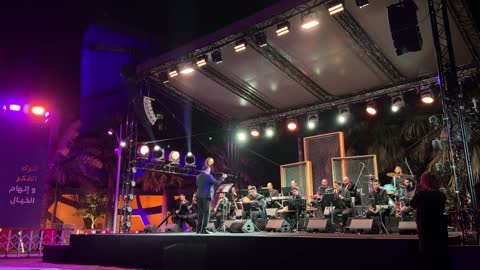 Orchestra Performance on Outdoor Stage at Night