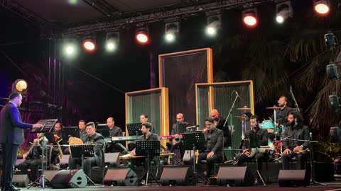 Orchestra Performing Traditional Music on Outdoor Stage