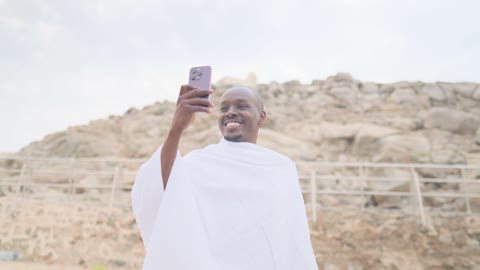 African Pilgrim Taking Selfie at Mount Arafat