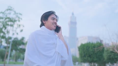 رجل بملابس الإحرام يتحدث بالهاتف في مكة فيديو