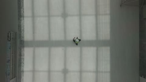 Construction Worker Walking Inside Building Top Down Drone
