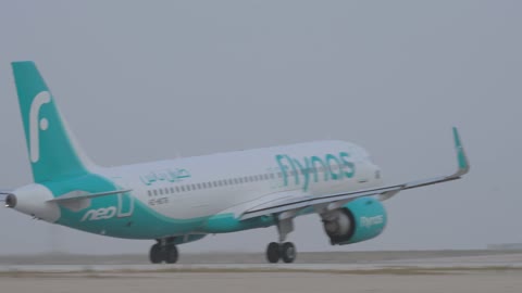 Flynas Airbus A320neo Airplane Takeoff from Desert Runway
