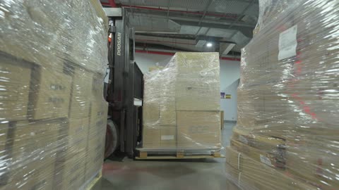 Forklift Moving Pallets in Industrial Distribution Warehouse