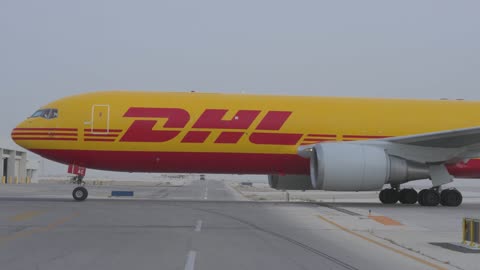 DHL Cargo Airplane Taxiing on Airport Runway