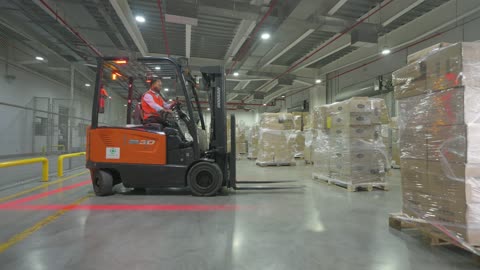Forklift Operator Driving in Industrial Warehouse Footage