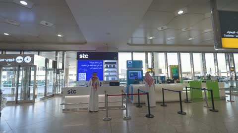 Saudi Men at Airport Telecom Service Counters