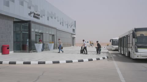 Airport Terminal Arrival Hall with Passengers and Bus