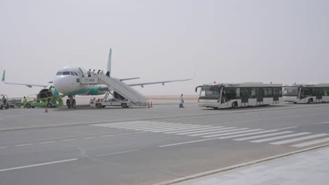 Passenger Aircraft and Shuttle Buses on Saudi Airport Tarmac