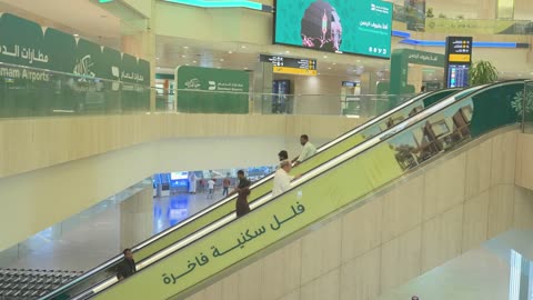 Movement of passengers and escalators at a Saudi airport.