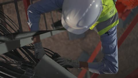 Telecommunications Technician Working On Tower Maintenance