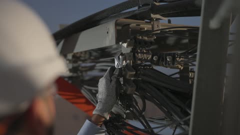 Technician Repairing Electrical Connections With Wrench