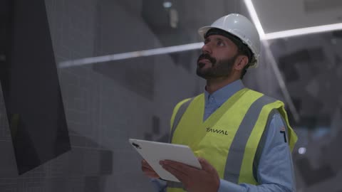 Saudi Engineer Using Digital Tablet for Site Inspection
