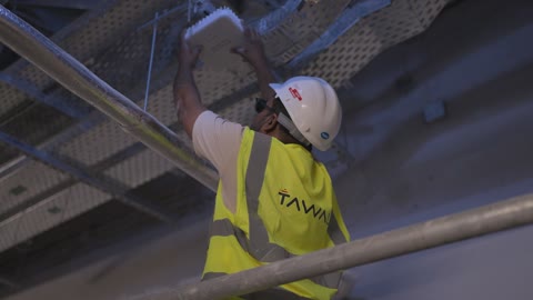 Technician Installing Wireless Access Point on Ceiling