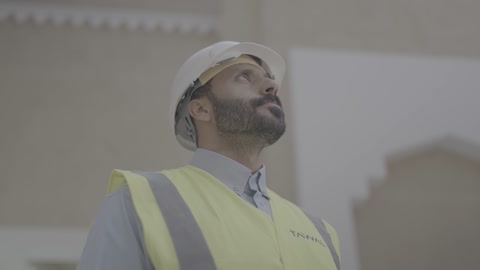 Saudi Engineer in Safety Gear Looking Upward
