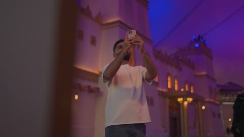 Arab Man Using Smartphone Photography at Night