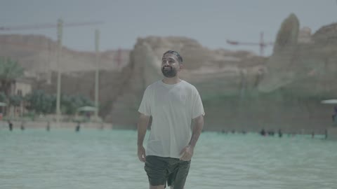 Middle Eastern Man Walking in Water Park Pool Daylight