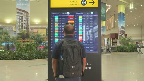 Traveler Viewing Flight Departure Board Dammam Airport