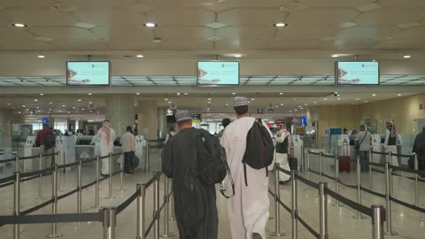 Omani Men Walking in Airport Terminal Footage