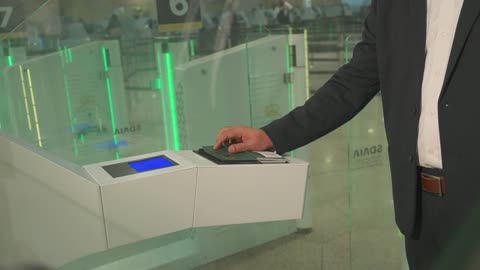 Businessman Scanning Passport at Automated Airport Gate