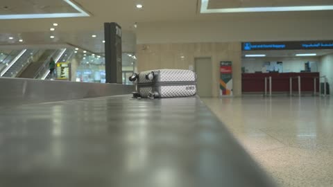 Suitcase on Airport Baggage Carousel Terminal