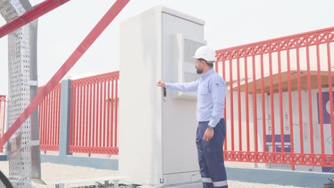 Telecom Engineer Inspecting Outdoor Server Cabinet