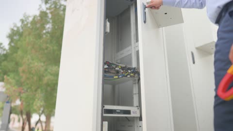 Telecom Technician Opening Outdoor Server Cabinet Footage