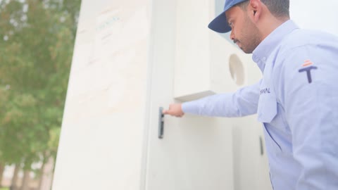 Arab Technician Opening Electrical Control Cabinet Outdoors