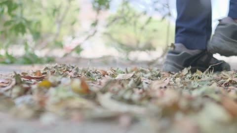 Hiking Boots Walking on Dry Autumn Leaves Footage