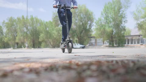 Man Riding Electric Scooter Outdoor Tracking Shot
