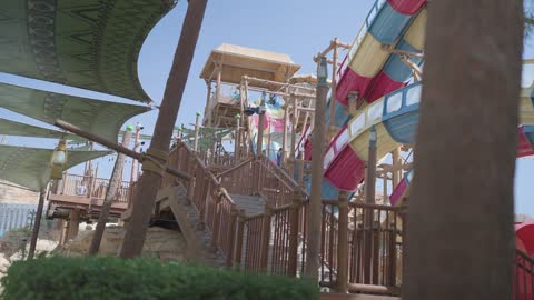 Waterpark Serpent Statue and Colorful Slides Footage