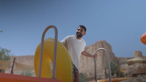 Middle Eastern Man at Water Park with Inflatable Tube