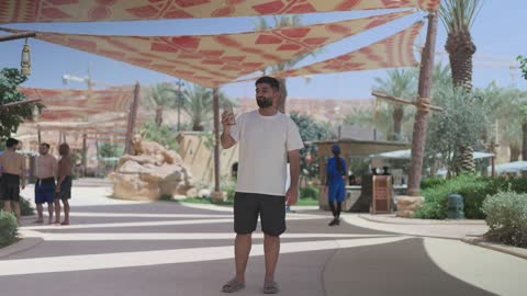 Saudi Man Using Smartphone in Theme Park
