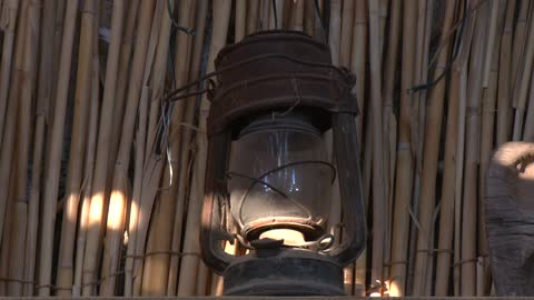 Antique Kerosene Lantern on Bamboo Wall Close Up