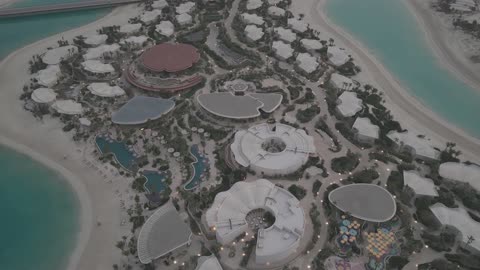 تصوير جوي بالدرون لمنتجع جزيرة سياحي فاخر وقت الغسق