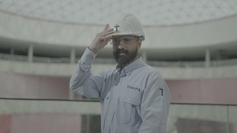 A Saudi engineer from Tawal Company in a modern building in Riyadh.