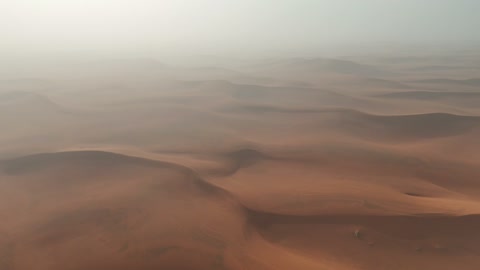 Aerial Drone Flight Over Hazy Desert Sand Dunes