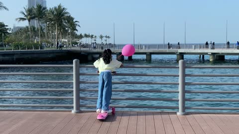 Girl on Pink Scooter at Jeddah Corniche Waterfront