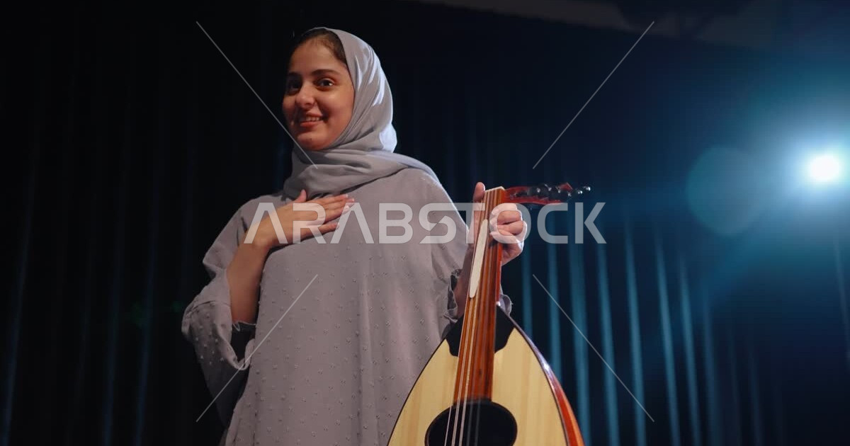A Saudi Gulf Arab woman playing the violin, spending pleasant times ...