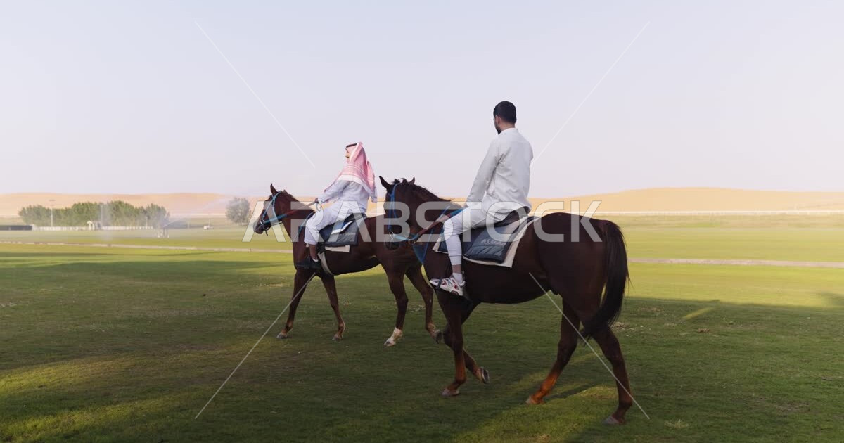 Two Saudi Arabian Gulf men riding horses, purebred Arabian horses