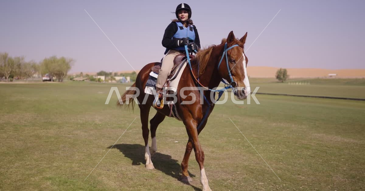 A young Saudi Arabian Gulf woman rides horses, purebred Arabian horses