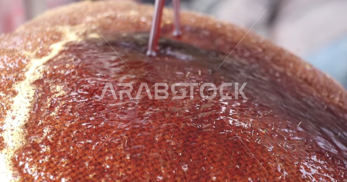 A closeup of the process of preparing licorice syrup, a cold drink